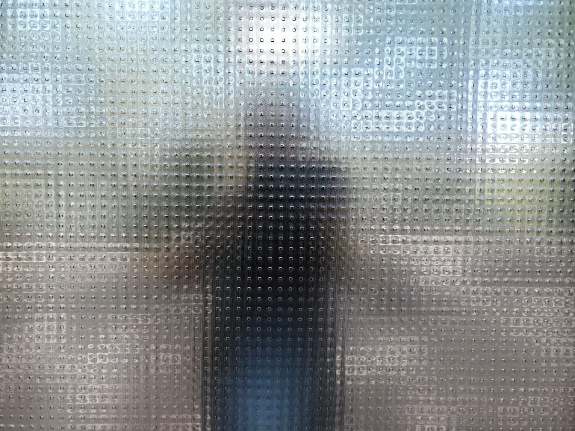 A Homeowner's Guide to Privacy Glass 3 - Angelo and Sons Shadowy Figure Behind Patterned Glass, Urban Commuter Silhouette With Backpack, Blurred Identity, Moody Light,